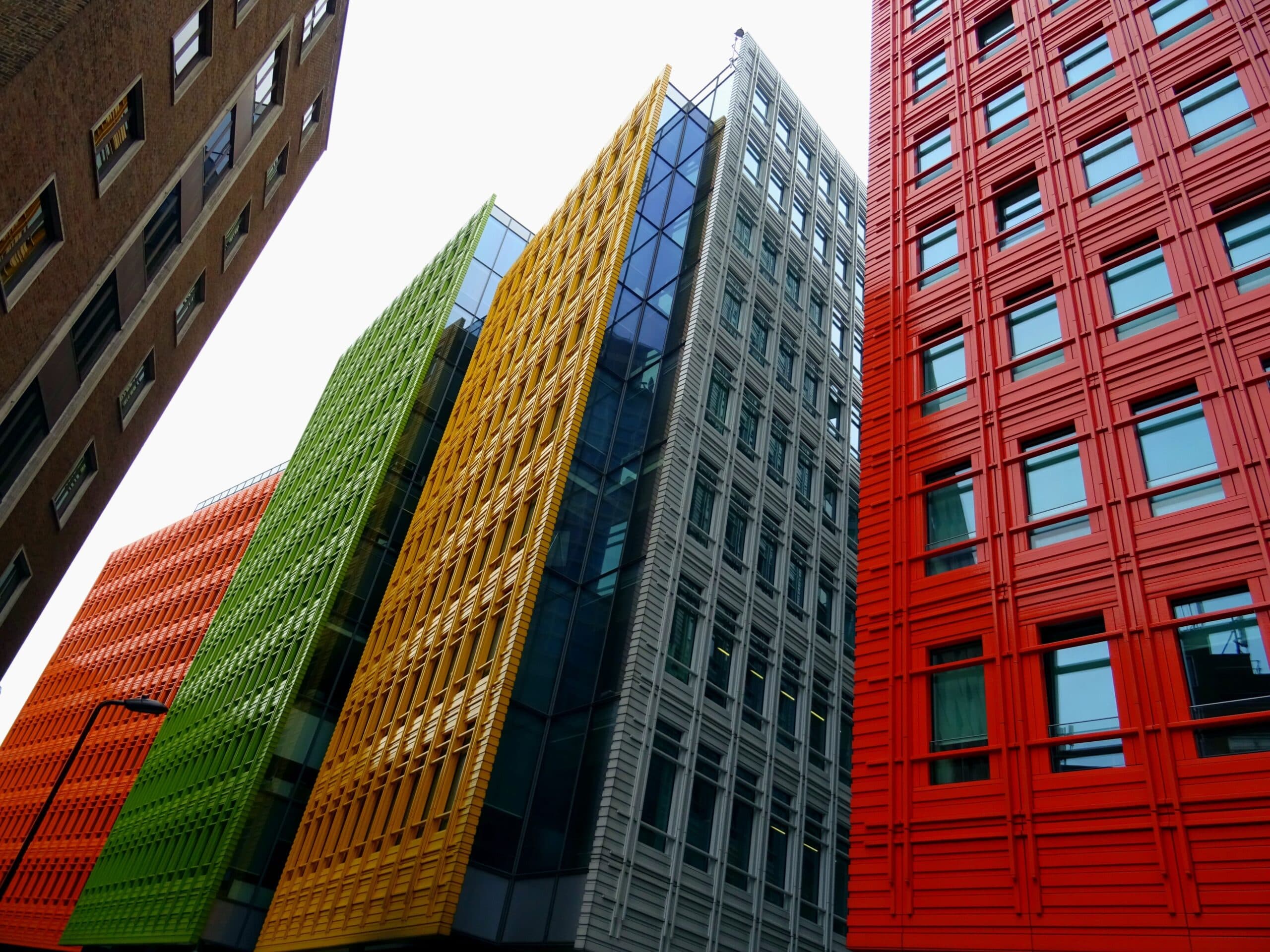 Colourful high-rise office buildings viewed from street level looking up